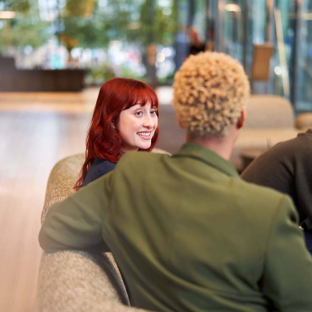 Colleagues in conversation on a sofa